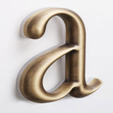 Vandal-Resistant Bronze Illuminated Logos for Urban Retail Complexes